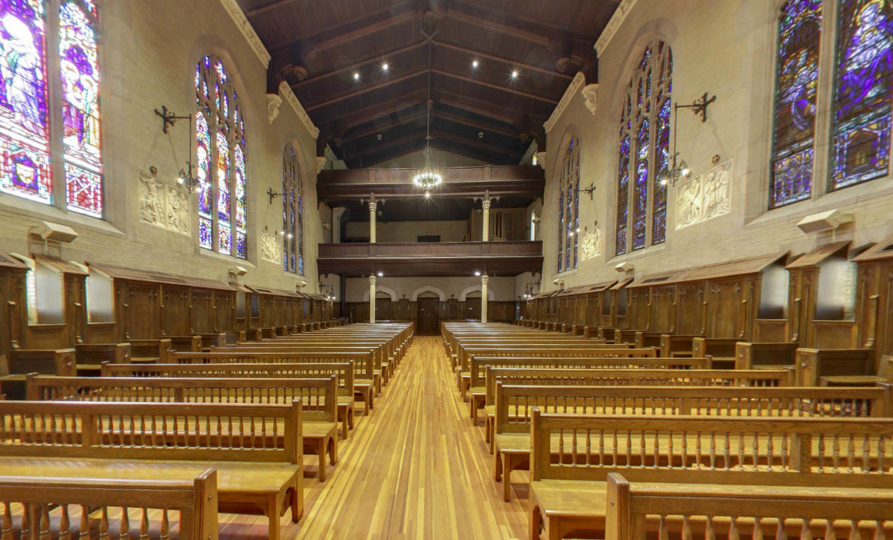 The shrine's nave and stained glass, seen from the sanctuary