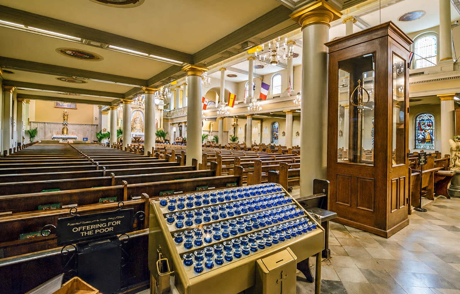 Votive candles and the side aisle looking toward the sanctuary
