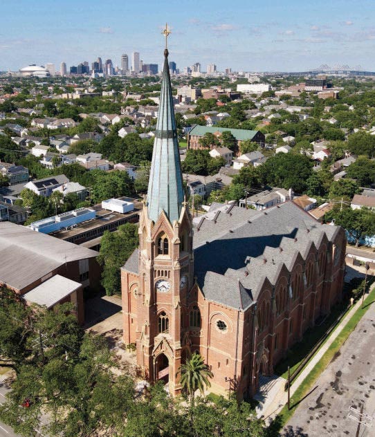 The basilica's spire above Uptown, with the downtown skyline beyond